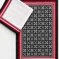 Handcrafted black, white and red cotton table runner with traditional geometric pattern.