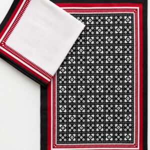 Handcrafted black, white and red cotton table runner with traditional geometric pattern.